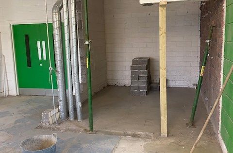 Empty room showing old cupboard with doors removed