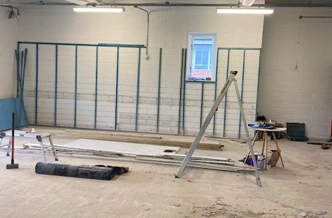 Empty room with floor removed with tools and stepladder